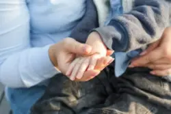 close-up of mother holding son’s hand