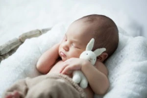 newborn baby sleeping in crib