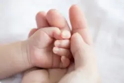 mother holding baby hand