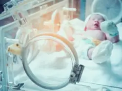 newborn baby inside incubator hospital