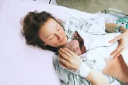 newborn rests on mother’s chest after birth