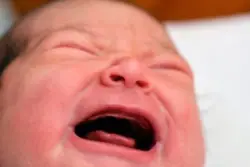 closeup of crying newborn.