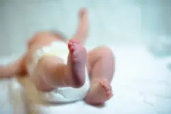 out-of-focus infant with feet facing camera