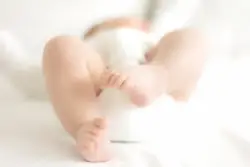 soft-focus shot of baby’s legs and feet