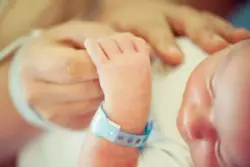 Parent Holds Hand Of Child With Hypoxic Ischemic Encephalopathy