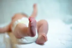 Newborn-baby-at-the-hospital-with-feet-in-the-air