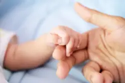 Newborn-baby-holds-parent-finger