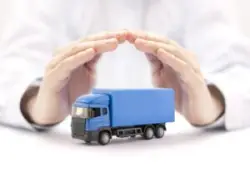 Hands cupped protectively over blue toy truck