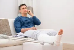 Man with broken leg sits on couch and call lawyer after getting hit by Fed-Ex truck