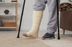guy in living room on crutches