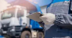 logistics worker doing truck paperwork