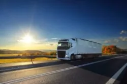 delivery truck on highway at sunset