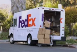 fed ex truck with packages stacked up against it