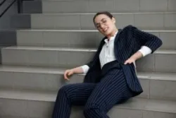 injured businesswoman lying on stairs