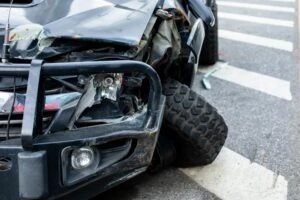 broken black car after a crash