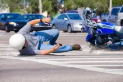 Man lies on street next to motorcycle after Waterbury accident
