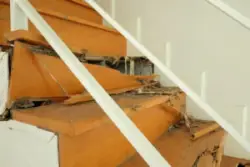 A set of badly damaged stairs that could cause an accident. After an injury, you can contact an Enfield premises liability lawyer.