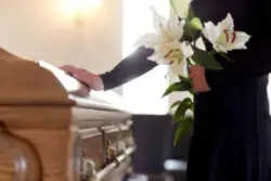 A woman at a funeral. Your family can work with an Enfield wrongful death lawyer to build a claim.