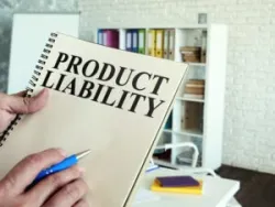 A Connecticut product liability attorney holds a manual labeled “product liability.”