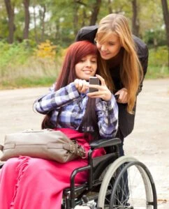 A relative helps a woman in a wheelchair call a Texas Long Term Disability lawyer.