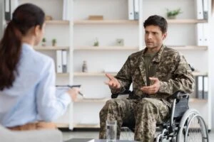 A veteran talks with a lawyer to learn more about VA Disability rates and pay chart for 2025. A VA Disability attorney can explain how the Cost of Living Adjustment (COLA) affects your monthly payment and pursue a higher disability rating if you think yours is too low.