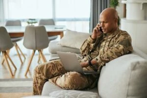 A U.S. veteran talks on a cell phone while using a laptop and wonders what happens during preparation for notification.