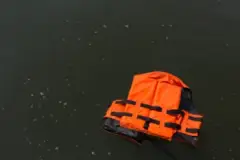 an orange life jacket floating in the water after a Miramar Beach boat accident