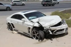 A totaled white car after a car accident. Call a Miramar Beach car accident lawyer today.