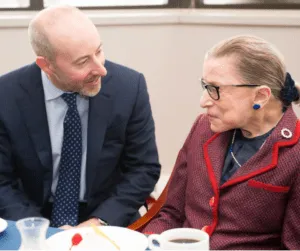 Shows Mark Gemma personal injury lawyer meeting Supreme Court Justice Ruth Bader Ginsburg at Roger Williams University School of Law.