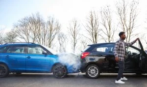 blue car and a black car in a rear end collision