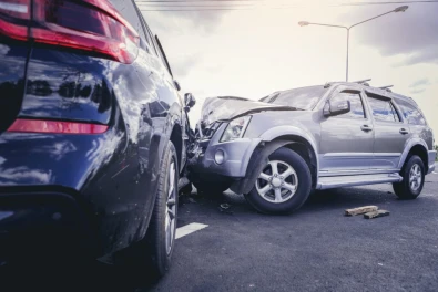 two cars that have been in a head on collision