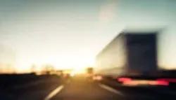 blurred image of truck driving on the highway