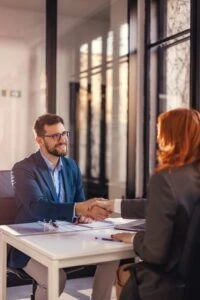 lawyer happily shaking hands with client