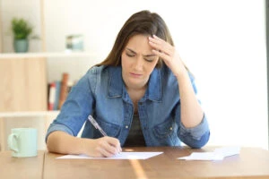 woman struggling to write a demand letter