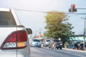 Drivers at an intersection waiting at a red light. Why do drivers run red lights?