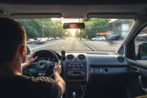 A driver speeding on the road, wondering how speeding increases the risk of severe accidents.