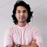 Man standing with arms crossed looking at the camera