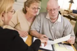 senior couple reviewing paperwork with an Ohio churning lawyer