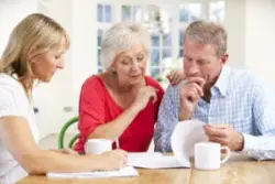 An investment loss recovery lawyer in Pennsylvania reviewing legal options with her senior clients.