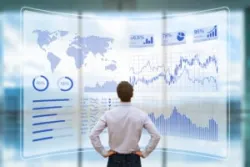 A financial professional examines a projection showing a detailed financial market analysis. An exchange traded note lawyer can explain more about what ETNs are backed by.