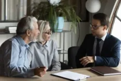 Lawyer explains risks of variable annuities to two investors.