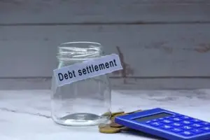 empty settlement jar next to a calculator