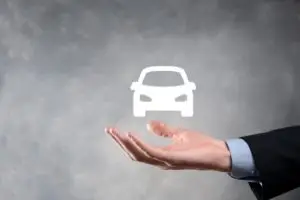 image of a man holding a car icon