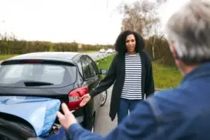 man and woman arguing over a car accident