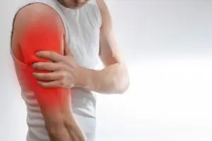 man holding arm in pain