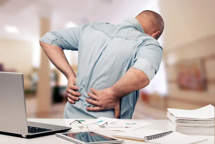 man with low back pain at work