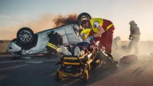 paramedics helping a victim at the scene of a car crash