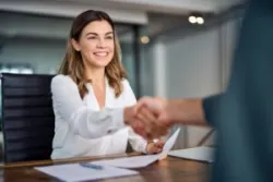 client happily shaking her lawyer’s hand