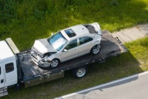 A car being towed on the highway after an accident. How to choose the best car accident lawyer.