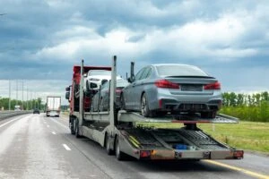 A tow truck towing cars to storage after a car accident. Who pays for this?